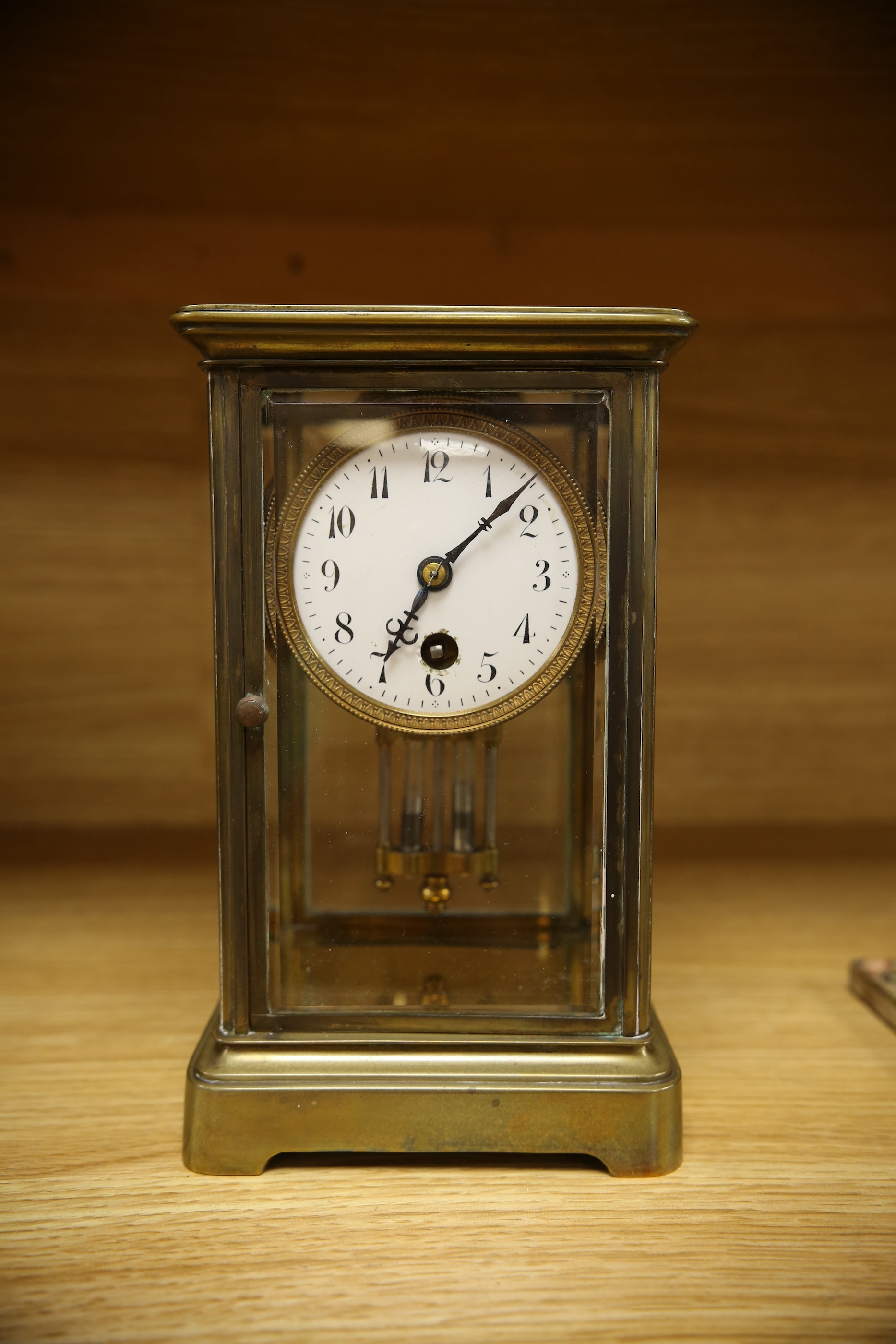 An early 20th century brass four glass mantel clock, 22cm. Condition - fair, not tested as working